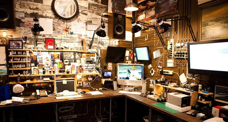 A photo of a corner of the Neistat Brothers New York studio, cable management speakers, and computers are all visible.
