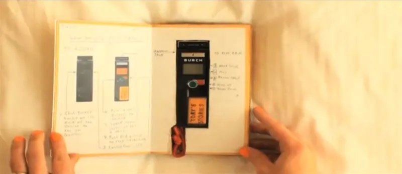 A cutout is carved into the pages of an open book to convert it into a carry case for an audio recorder.
